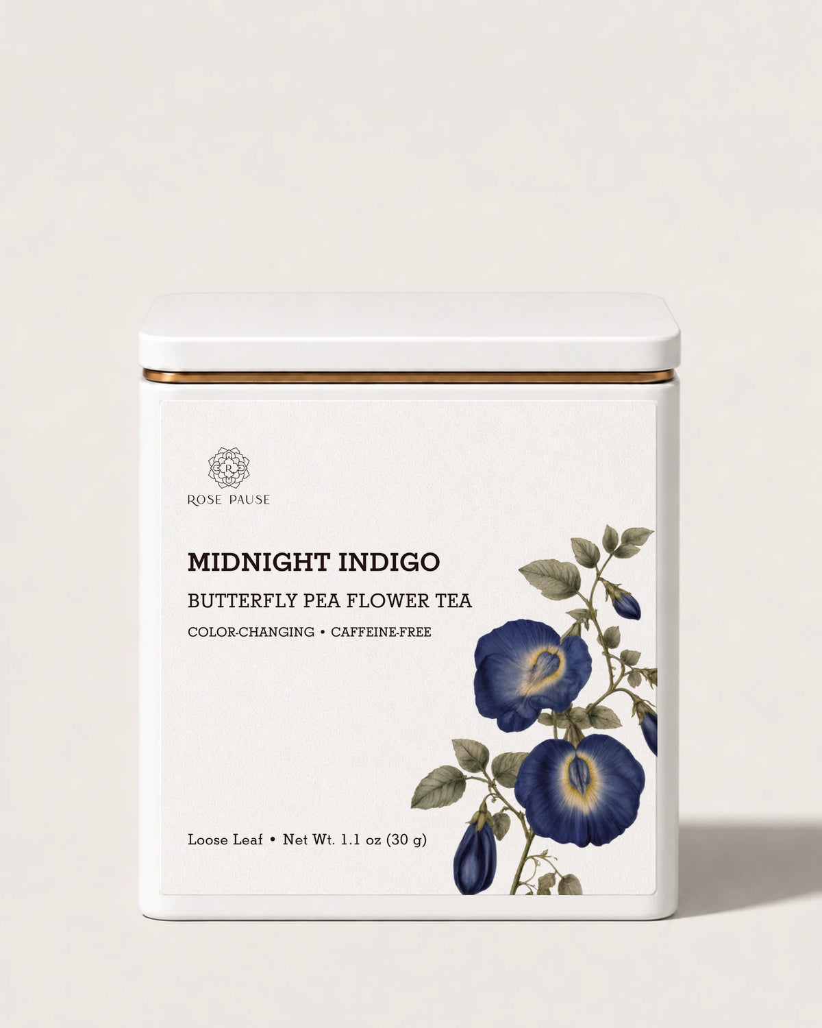 Rose Pause Midnight Indigo butterfly pea flower tea in a white 30 g tin with a blue floral label.