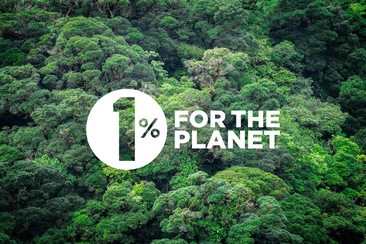 White 1% for the Planet logo over a dense green forest canopy.